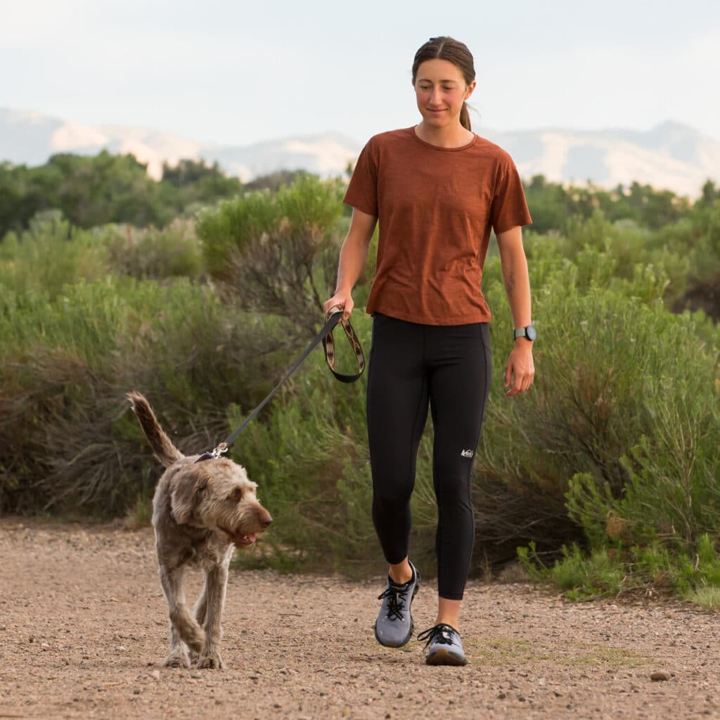 Person walking their dog with a Flur easy-dose sachet in their hand